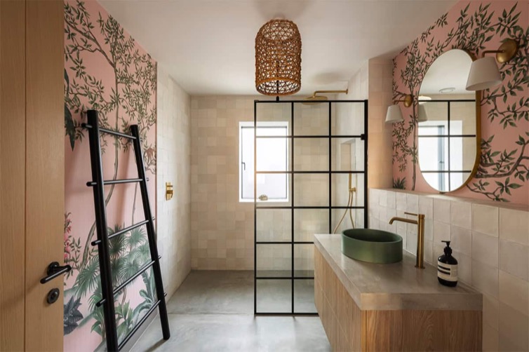 Hazelbridge Cottage shower room with pink botanical wallpaper, Crittall screen, and rattan pendant